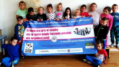 Kandydaci na mistrzów szachownicy z promocyjnym bannerem...