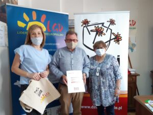 Grupa grantobiorc&oacute;w pozuje do&nbsp;zdjęcia pokazując podpisane umowy